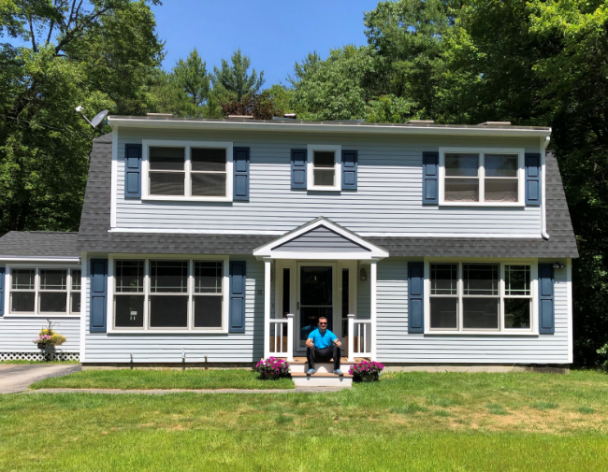 Man sitting on front stoop of home