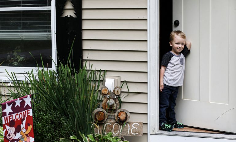 small child walking through a doorway